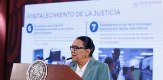 Rosa Icela Rodriguez standing at a podium behind a large display screen that says "fortalecimiento de la justicia"