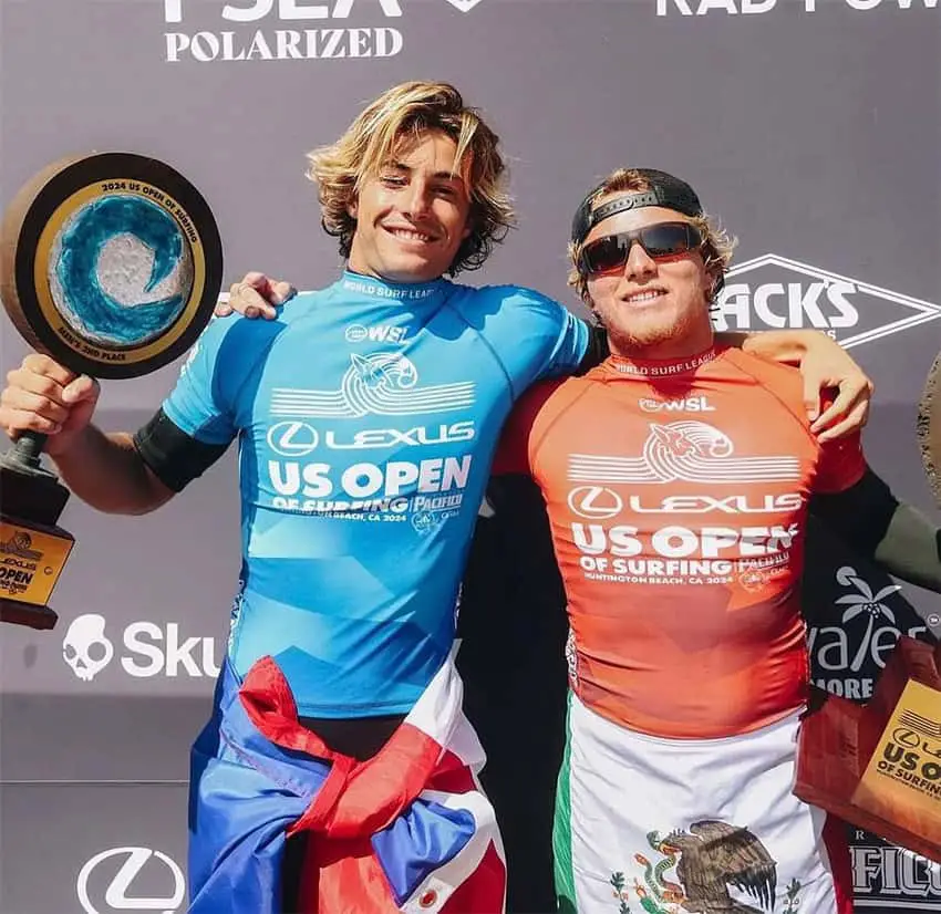 Surfers Alan Cleland and Marco Mignot hold trophies after the US Open of Surfing.