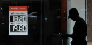 A Banregio currency exchange sign shows the dollar-peso exchange rate, as the Mexican peso strengthens.