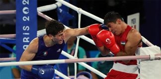 Mexican boxer Marco Verde fights Asadkhuja Muydinkhujaev of Uzbekistan at the Paris 2024 Olympics.