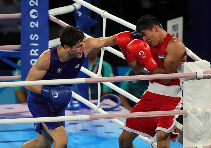 Mexican boxer Marco Verde fights Asadkhuja Muydinkhujaev of Uzbekistan at the Paris 2024 Olympics.