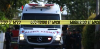 An ambulance rushes to the scene of a homicide.