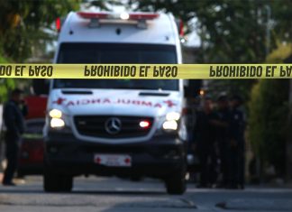 An ambulance rushes to the scene of a homicide.