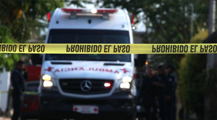 An ambulance rushes to the scene of a homicide.