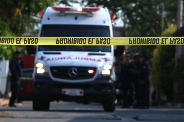 An ambulance rushes to the scene of a homicide.