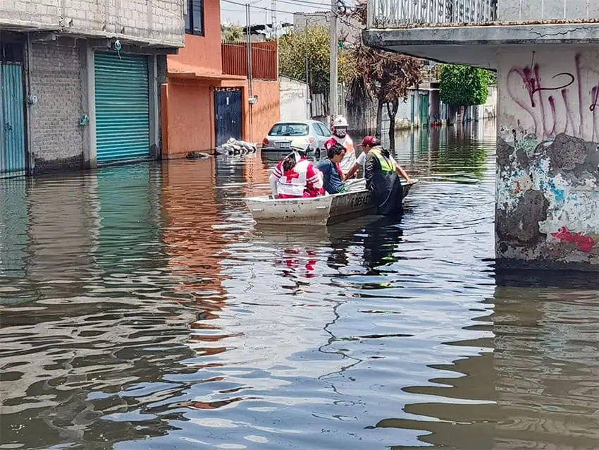 Red Cross volunteers help residents evacuate from flooding in Chalco, Mexico