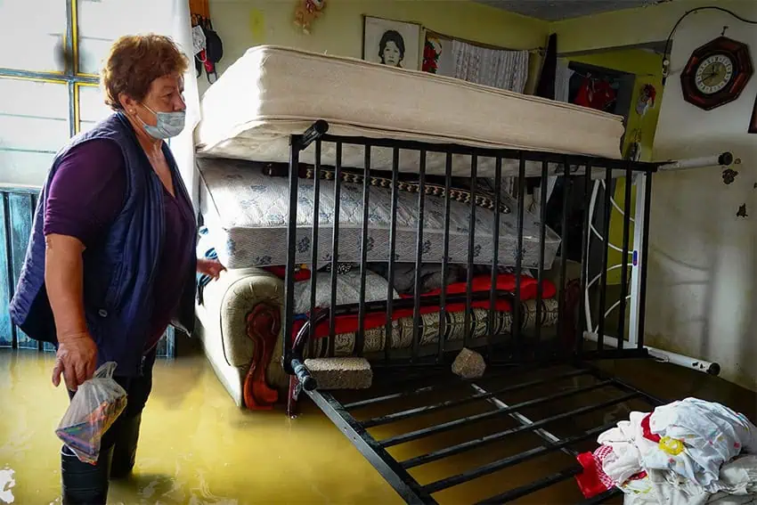 A woman looks at her living room, filled with sewage due to flooding in Chalco, Mexico.