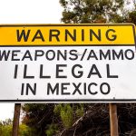 A sign in San Diego, California, warns against bringing guns and ammo into Mexico, where such products can only be legally purchased at an army-run store in Mexico City.
