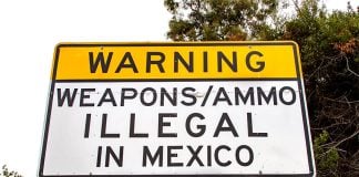A sign in San Diego, California, warns against bringing guns and ammo into Mexico, where such products can only be legally purchased at an army-run store in Mexico City.