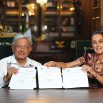 AMLO and Claudia Sheinbaum hold up the signed judicial reform bill