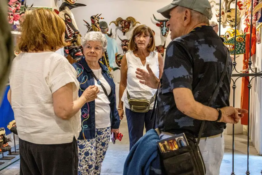 A group of foreigners talking in the middle of an art room.