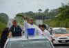 Father Baxin of Santa Ana church in Soconusco, Veracruz, stood in the back of a pick-up truck sprinkling holy water along federal Highway 180.