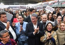 Deputy Ricardo Monreal stands at the front of a crowd celebrating the passage of the judicial reform bill in Mexico's Chamber of Deputies