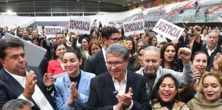 Deputy Ricardo Monreal stands at the front of a crowd celebrating the passage of the judicial reform bill in Mexico's Chamber of Deputies