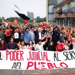 UNAM students protest in Mexico City holding a banner that says "El poder judicial al servicio del pueblo"