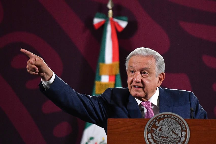 Mexican President López Obrador stands at a podium, speaking in favor of judicial reform