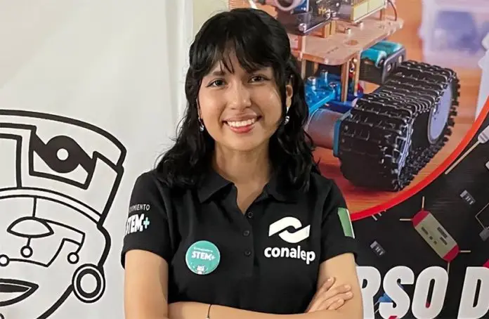 Mexican student Ángela Elena Olazarán poses for a photo with graphics of robots in the background