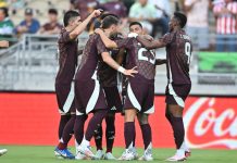 The Mexican men's soccer team hugs and celebrates after beating New Zealand