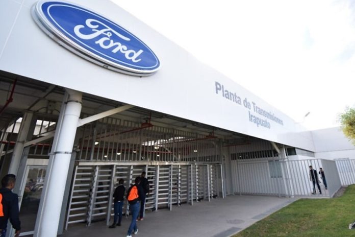 Ford manufacturing plant entrance in Irapuato, showing the Ford logo and a sign saying Planta de Transmissiones Irapuato.