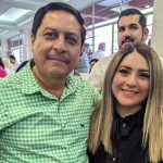 Frontera Comalapa, Chiapas, Mayor-elect Anibal Roblero standing posing for a photo with a young woman with people at an event standing around in the background