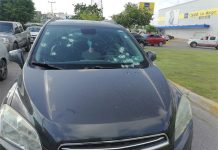 A car with multiple bullet holes in its windshield, stopped on the side of a street in Mazatlán, Sinaloa