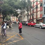 Mexico City residents stand in the street in an earthquake evacuation area, after a series of micro-quakes