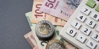 Mexican peso bills, coins and a calculator