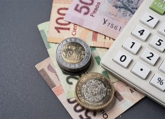 Mexican peso bills, coins and a calculator