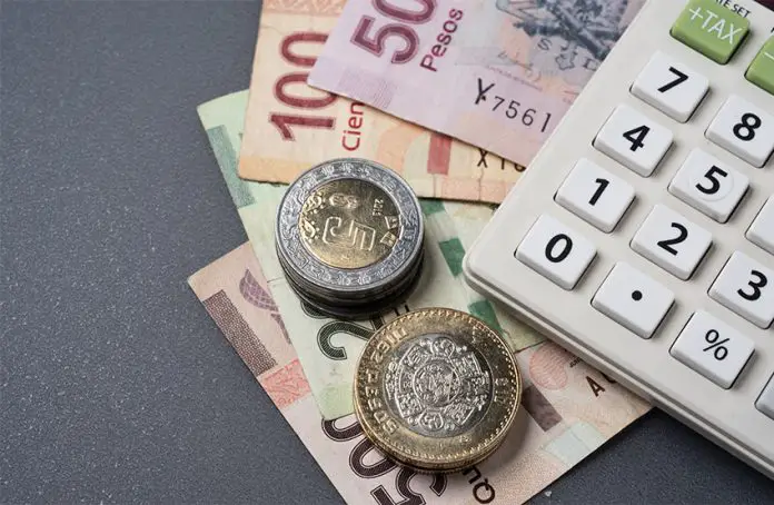 Mexican peso bills, coins and a calculator