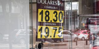 A sign in Mexico City displays the peso-dollar exchange rate.