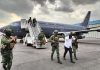 Sedena officials escort a El Piyi off an Air Force plane after his arrest in Sinaloa