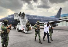 Sedena officials escort a El Piyi off an Air Force plane after his arrest in Sinaloa