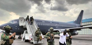 Sedena officials escort a El Piyi off an Air Force plane after his arrest in Sinaloa
