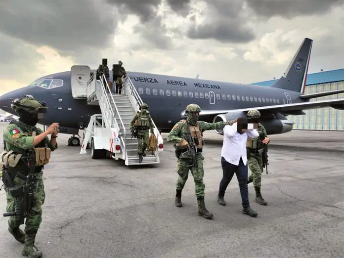 Sedena officials escort a El Piyi off an Air Force plane after his arrest in Sinaloa