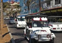 White golf cart taxis driving on the cobblestone streets of downtown Mazatlan, Mexico