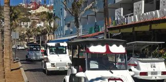 White golf cart taxis driving on the cobblestone streets of downtown Mazatlan, Mexico