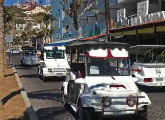 White golf cart taxis driving on the cobblestone streets of downtown Mazatlan, Mexico