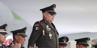 Army General Ricardo Trevilla Trejo stands at a dias in full military regalia
