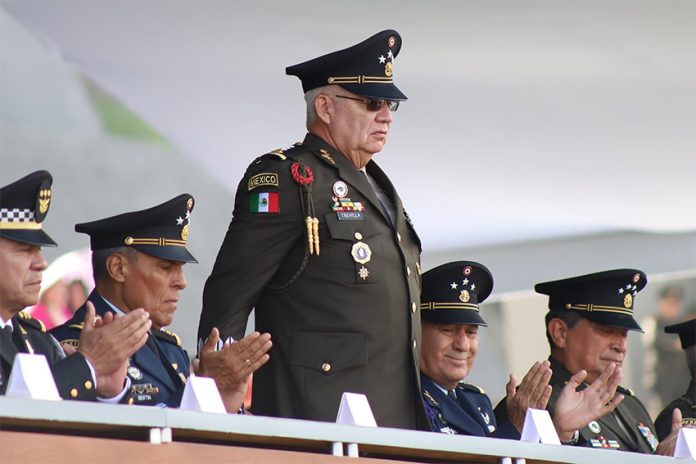 Army General Ricardo Trevilla Trejo stands at a dias in full military regalia