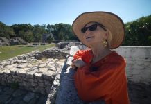 Older foreign woman enjoying life in an archeological site in Mexico.