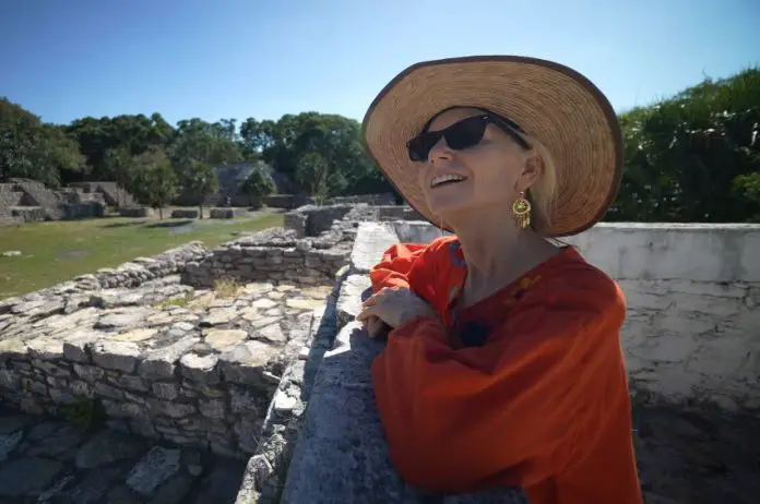 Older foreign woman enjoying life in an archeological site in Mexico.