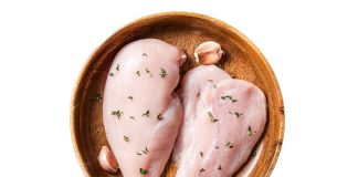 Chicken breast in a wooden dish, of the type used to make mezcal de pechuga