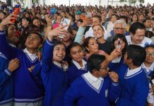 Sheinbaum with school children during an event to announce the scholarship