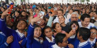Sheinbaum with school children during an event to announce the scholarship