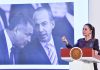 President Claudia Sheinbaum stands at a podium in front of a photo of Felipe Calderón and Genaro García Luna.