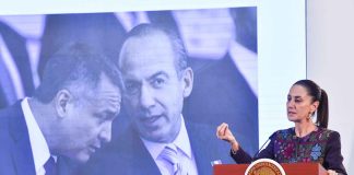 President Claudia Sheinbaum stands at a podium in front of a photo of Felipe Calderón and Genaro García Luna.