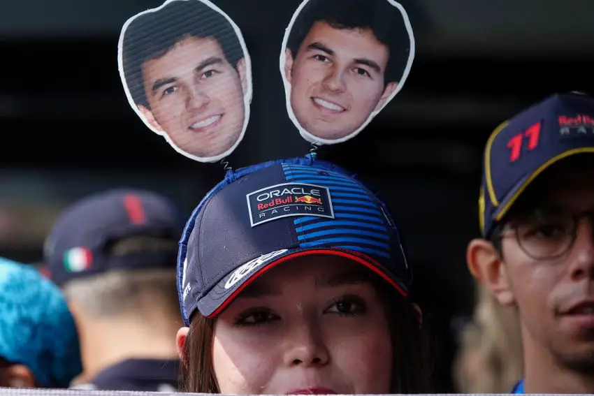 A girl wears cutouts of Checo Pérez on a headband at the Mexico Grand Prix