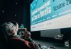 A older man looks up at screen that reads "Festival Internacional de Cine de Morelia" at the 2024 Morelia International Film Festival