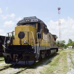 Yellow railroad locomotive engine car on a railroad track