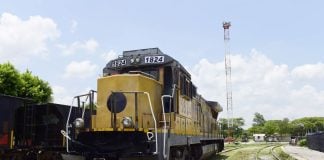 Yellow railroad locomotive engine car on a railroad track